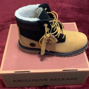 Brand new Timberland boots in grade school size. Wheat and black two colored .